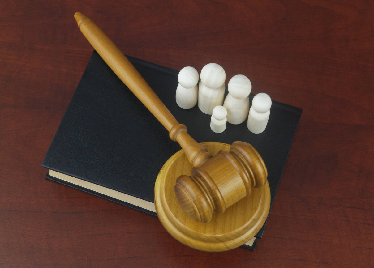 Family people figures on legal book with judge gavel